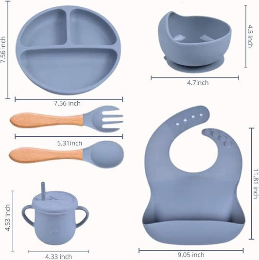 Children's dining set with blue plate, bowl, cups, utensils, and bib with measurements on a white background.