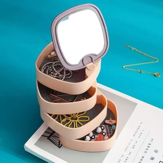Three-tiered jewelry organizer with mirror on a blue background