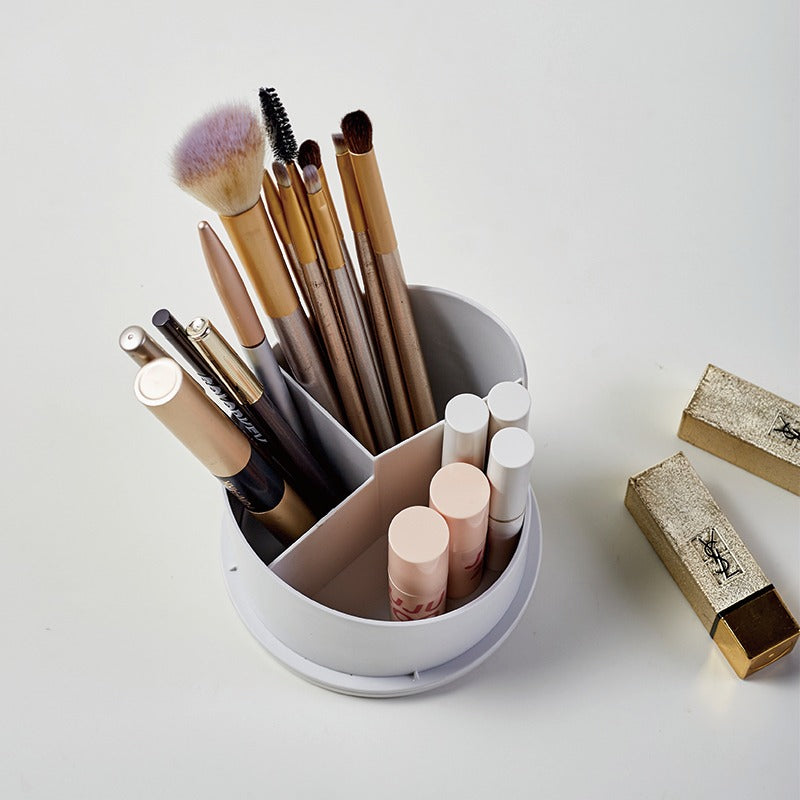 Makeup brushes and lip products in a white holder on a light gray background