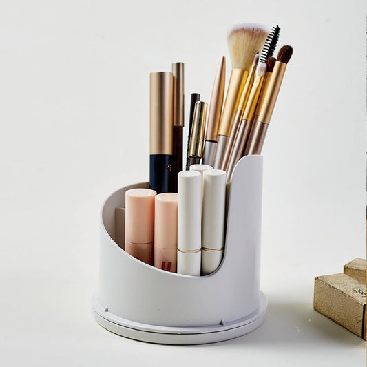 White cylindrical makeup organizer with brushes and bottles on a white background