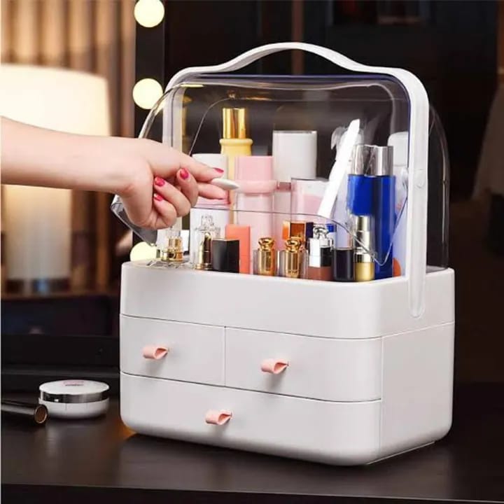 White cosmetic organizer with drawers filled with makeup products on a dark surface.