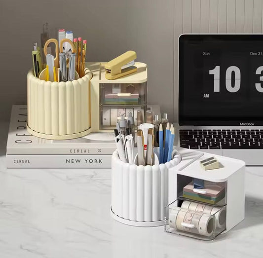 Desk organizer with stationery items next to a laptop on a marble surface.