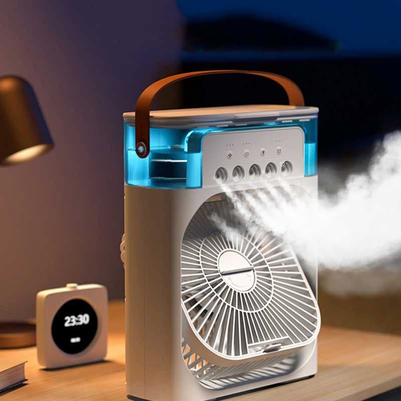 Portable fan with mist output on a table next to a clock and lamp.