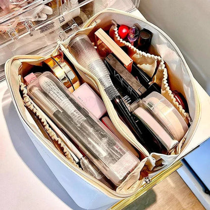 structured leather makeup bag standing on bathroom counter